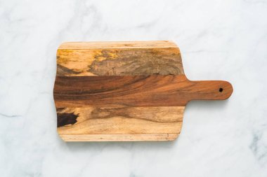 Rustik ahşap kesme tahtası üzerinde mermer tezgah.