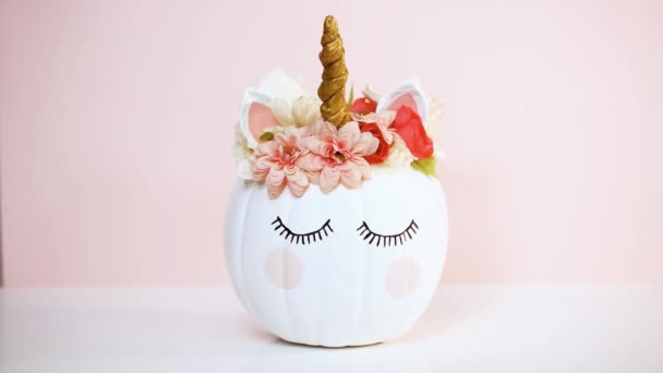 Craft Pumpkin Painted White Decorated Pink Flowers Unicorn Pink Background — Stock Video