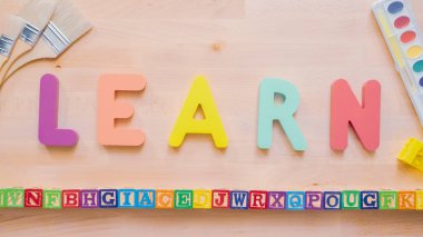 Kelime öğrenmek çok renkli ahşap mektup ahşap masa üstünde üzerinden.