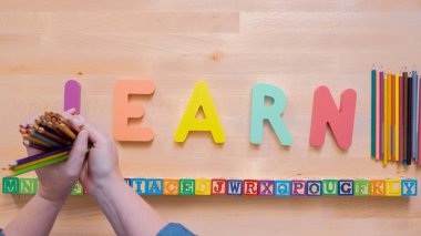 Kelime öğrenmek çok renkli ahşap mektup ahşap masa üstünde üzerinden.