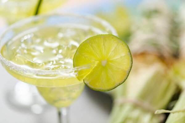 Lime margaritas on the rocks garnished with fresh slice of lime.