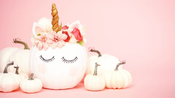 White Unicorn Pumpkin Decorated Flowers Pink Background — Stock Video