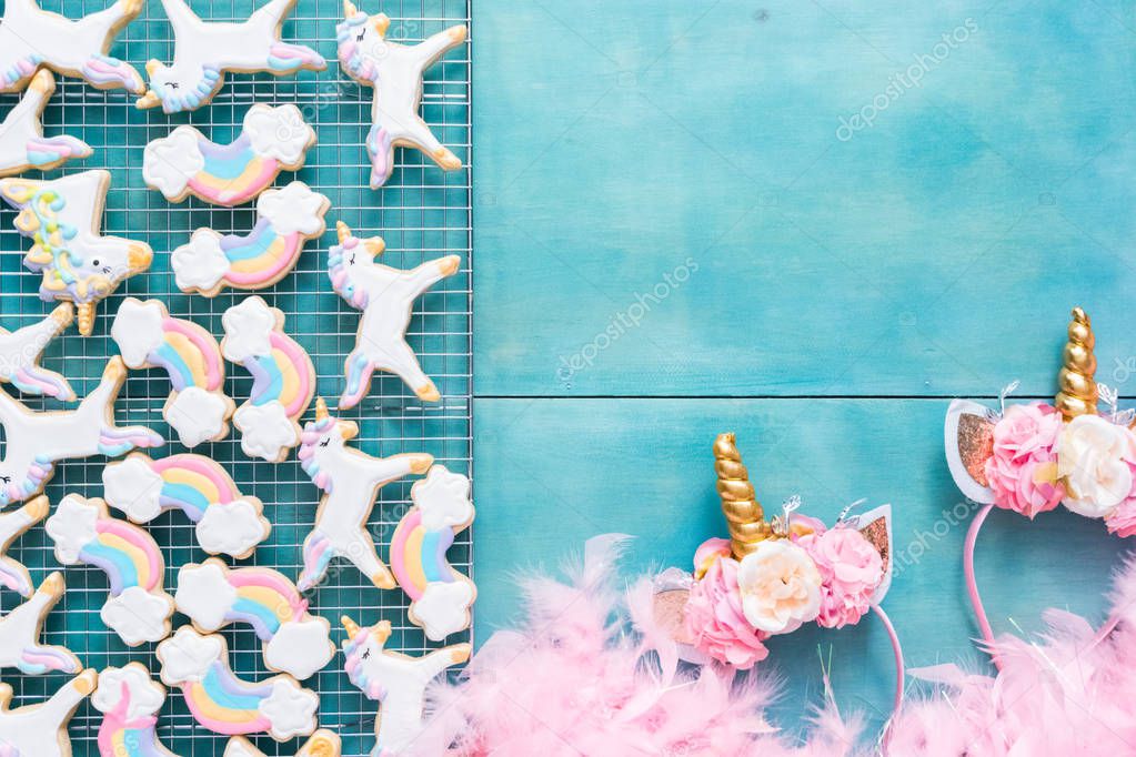 Unicorn sugar cookies decorated with royal icing on a blue background.