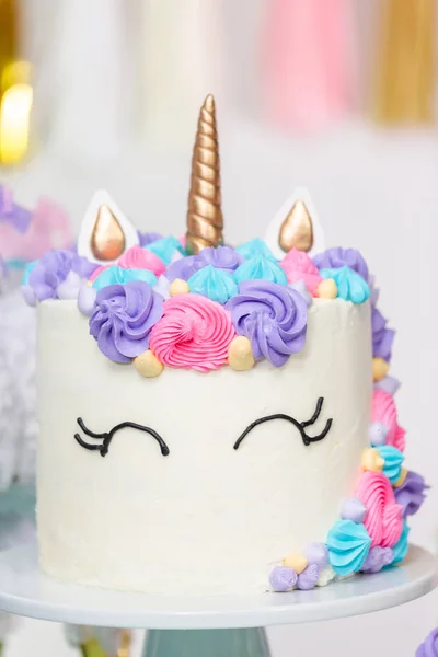 Close up of unicorn cake at little girl birthday party.