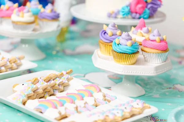 Unicorn sugar cookies on serving tray at little girl birthday party.