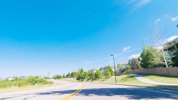 Driving on paved roads in suburban neighborhood south of Denver, Colorado.