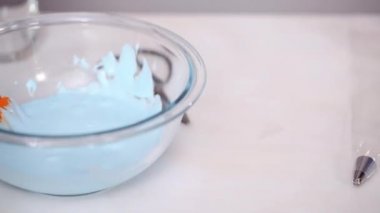 Zaman atlamalı. Adım adım. Gıda tek boynuzlu at şekerli kurabiye süslemek için Royal Icing içine boyama karıştırma.