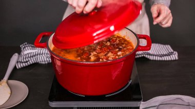 Step by step. Cooking turkey chili in enameled cast iron covered dutch oven. clipart