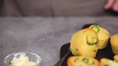 Kadın şef kurulu Mısır ekmeği ve jalapeno muffins ile masaya taşıma Close-up