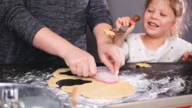 Anne ve kızı kesme şeker kafatası hamur ürünleri Dia de los Muertos tatil için.