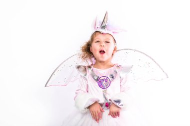 Glitter tek boynuzlu at kostüm beyaz arka plan üzerinde küçük bir kız portresi.