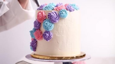 Baker boru pastel renk buttercream rozet beyaz bir pastayı tek boynuzlu at yapmak kek.