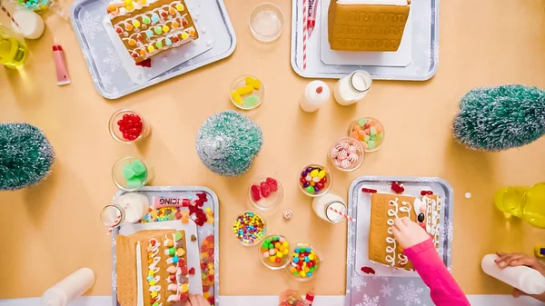 Flat Lay Kids Decorating Small Gingerbread Houses Christmas Craft Party — Stock Photo, Image