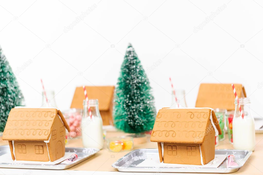 Kids party to decorate small gingerbread houses  with candies.