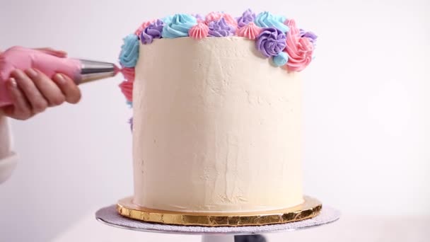 Baker Σωληνώσεις Παστέλ Χρώμα Buttercream Ρόδακες Ένα Άσπρο Κέικ Κάνει — Αρχείο Βίντεο