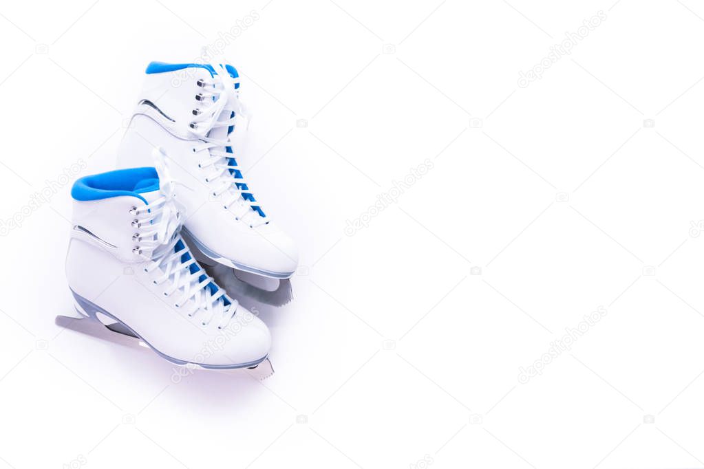 Flat lay. New white figure skates on a white background.
