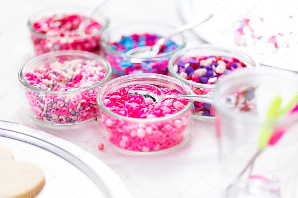 Variety of pink sprinkles for decorating Valentine's day cookies.