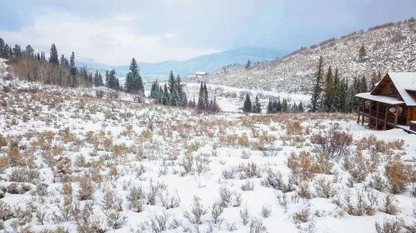 冬の雪に覆われた山の家の空撮 — ストック写真