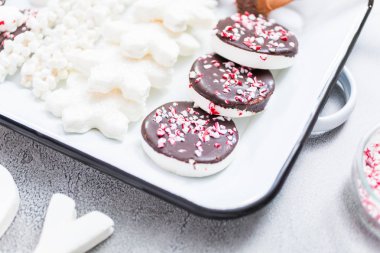 Close up view. Variety of marshmallow toppings with peppermint and chocolate for hot chocolate and cocoa drinks. clipart