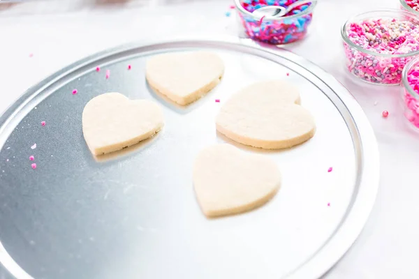 Decorating Heart Shape Sugar Cookies Royal Icing Pink Sprinkles Valentine — Stock Photo, Image