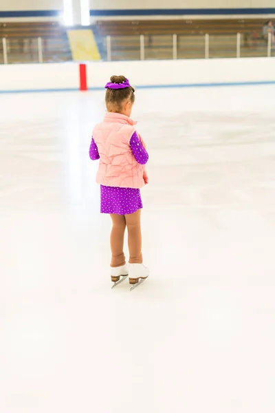 女の子練習フィギュアスケートでパープルドレスとともに結晶でザ室内アイススケートリンク — ストック写真