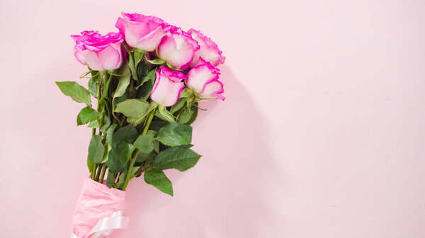 Flat lay. Step by step. Florist arranging a bouquet from pink roses.