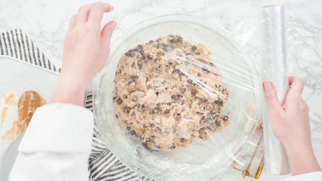 Step by step. Flat lay. Mixing ingredients in a glass bowl to make chocolate chip cookies.