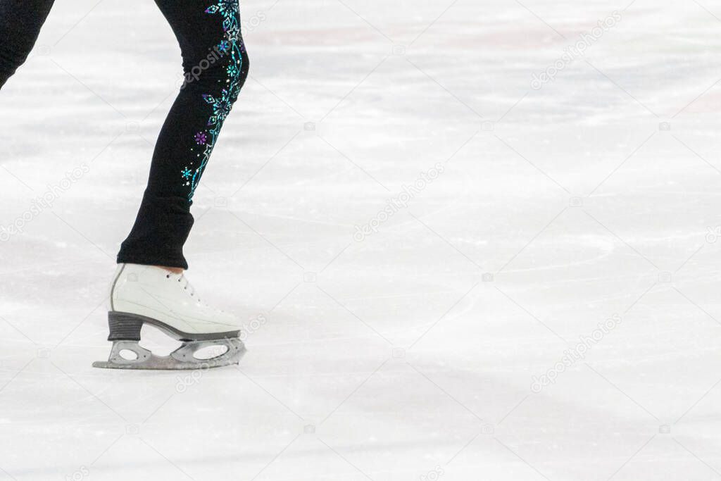 View of figure skater feet at the figure skating practice.