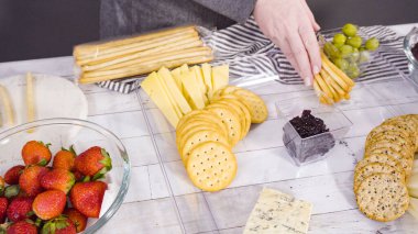 Adım adım. Taze meyve, gurme peynir ve kraker ile peynir tabağı hazırlıyorum..