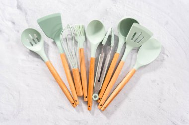 Düz yatıyordu. Ahşap saplı silikon pişirme aletleri.