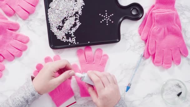 Flat Lay Rhinestone Pink Kids Gloves Snowflake Shapes — Stock Video