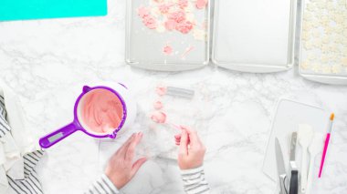 Düz yatıyordu. Adım adım. Erimiş çikolatayı kar taneleri şeklinde plastik bir çikolata kalıbına döküyorum..