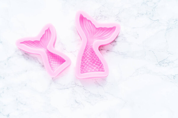 Mermaid theme silicone molds with sea stars and memaid tails.