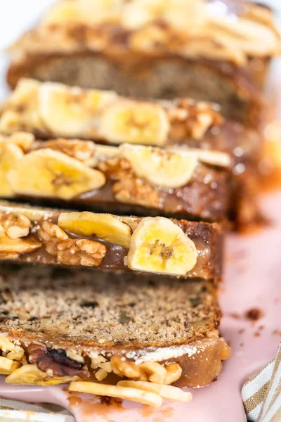 Sliced Loaf Banana Nut Bread Drizzled Homemade Caramel Pink Cutting — Stock Photo, Image