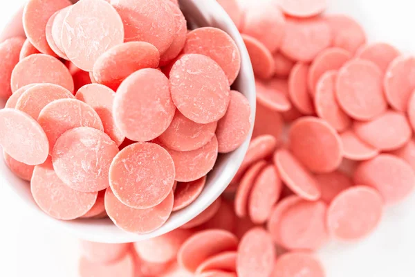 Pink Chocolate Chips Melting Chocolate Shapes White Background — Stock Photo, Image