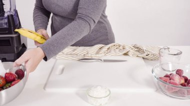 Mutfak blendırında çilekli ve muzlu smoothie hazırlıyorum..