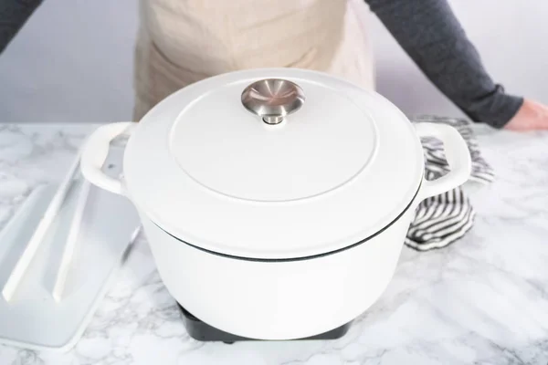 Cooking White Enameled Cast Iron Dutch Oven — Stock Photo, Image