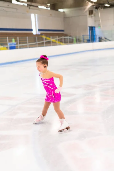 Pembe Elbiseli Küçük Artistik Patinajcı Kapalı Buz Pistinde Pratik Yapıyor — Stok fotoğraf