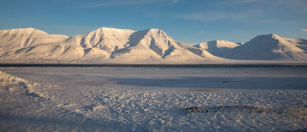 Snow covered mountains seen from Longyearbyen in Svalbard.