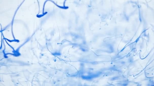 Close-up blue ink being poured into water. — Stock Video