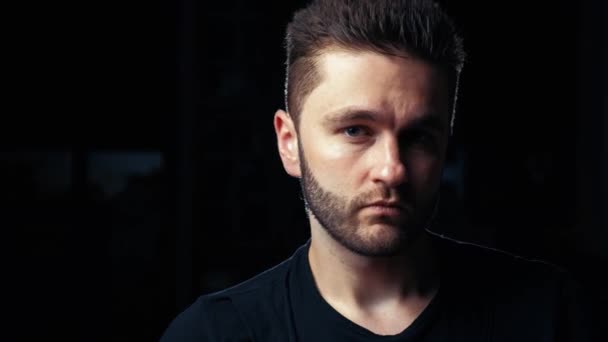 Portrait of a handsome positive man with a beard on a black background — Stock Video