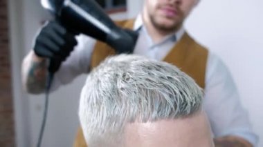 Salonda erkek saç modeli. Adam saç kurutma kuaför dükkanı. Styling saç kurutma makinesi ile berber. Kuaförlük bitirmek. Berber saç kurutma makinesi erkekte