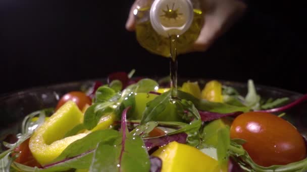 Oil pouring over mixed salad — Stock Video