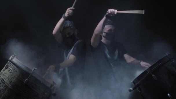 두 사람이 검은 배경에 색상 드럼 재생 — 비디오