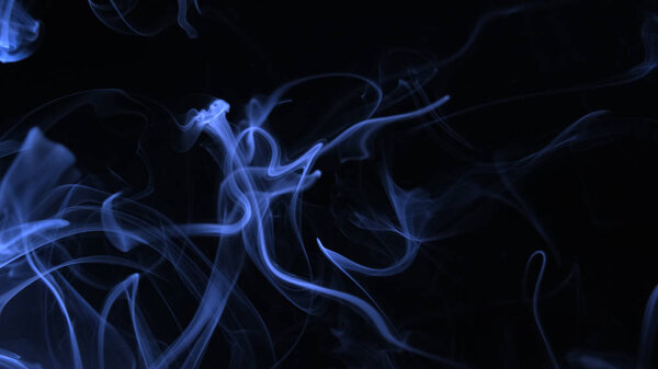Blue color smoke on the black background.