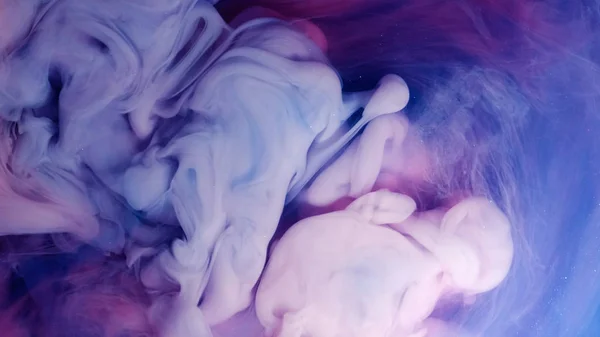 Blue pink clouds of ink in liquid. black background — Stock Photo, Image