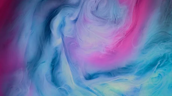 Blue pink clouds of ink in liquid. black background — Stock Photo, Image