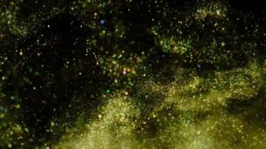 Altın kum yavaş yavaş siyah bir arka plan üzerinde hareket eder