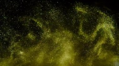 Altın kum yavaş yavaş siyah bir arka plan üzerinde hareket eder