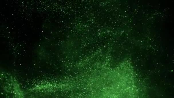 De explosie van groene deeltjes op een zwarte achtergrond. — Stockvideo